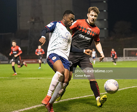Tunde Owolabi of St Patrick's Athletic sees Rory Feeley of Bohemian FC clip the ball out of play
